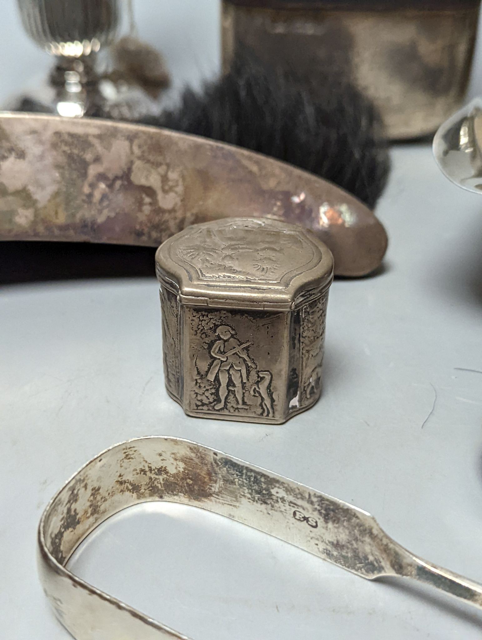 A group of assorted silver items including George V silver mounted hip flask(bruise), a pair of silver sauceboats(a.f.) one other sauceboat, sterling box, two silver cream jugs, cigarette box, salt, sugar tongs, brush an